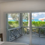 ocean-club-beachfront-condo-suite-1103 primary bedroom suite to balcony view