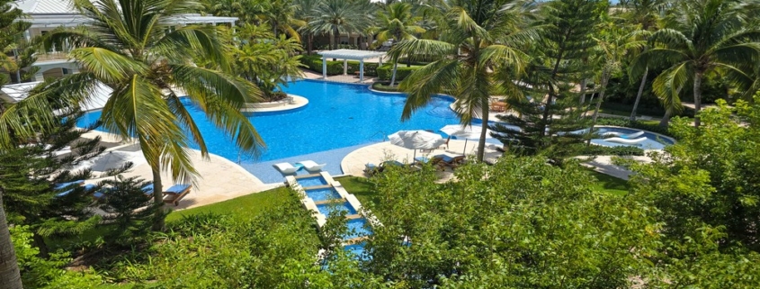 pinnacle-suite-303-3-bed-grace-bay-beachfront-condo pool and landscaping view