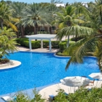 pinnacle-suite-303-3-bed-grace-bay-beachfront-condo pool and landscaping view