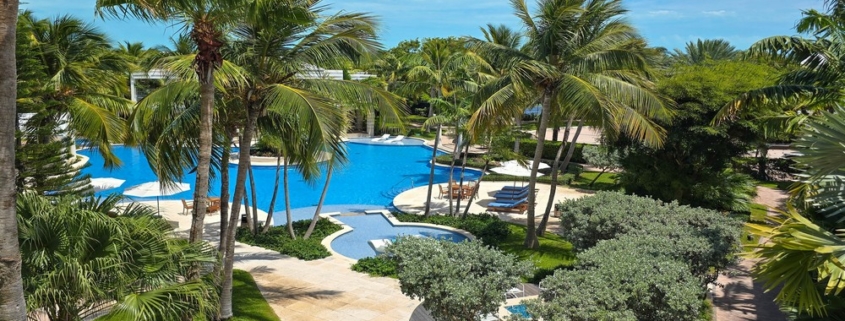 pinnacle-suite-303-3-bed-grace-bay-beachfront-condo pool and landscaping view