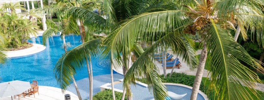 pinnacle-suite-303-3-bed-grace-bay-beachfront-condo pool and landscaping view