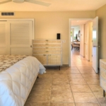 ocean-club-west-suite-511-one-bedroom-bedroom view to hallway and bathroom ensuite