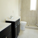 turks-caicos-house-for-sale-leeward-interior bathroom with vanities toilet and shower