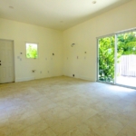 turks-caicos-house-for-sale-leeward-interior kitchen and backyard view through patio doors