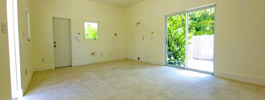 turks-caicos-house-for-sale-leeward-interior kitchen and backyard view through patio doors