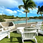 waterfront-turks-caicos-homes-for-sale-palm-point lounge area lawn bbq pit