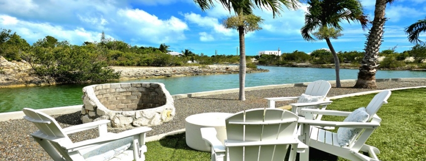 waterfront-turks-caicos-homes-for-sale-palm-point lounge area lawn bbq pit