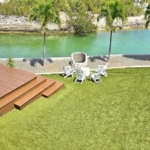 waterfront-turks-caicos-homes-for-sale-palm-point-upper level apartment view of gardens, deck and canal