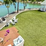 waterfront-turks-caicos-homes-for-sale-palm-point-upper level apartment view of gardens, deck and canal