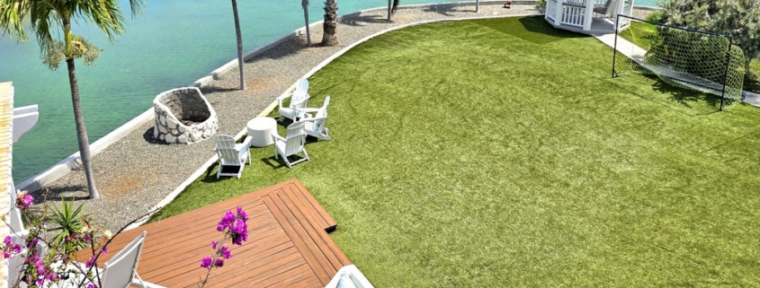 waterfront-turks-caicos-homes-for-sale-palm-point-upper level apartment view of gardens, deck and canal