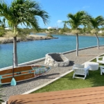 waterfront-turks-caicos-homes-for-sale-palm-point-view of canal, firepit, seating and paddle board