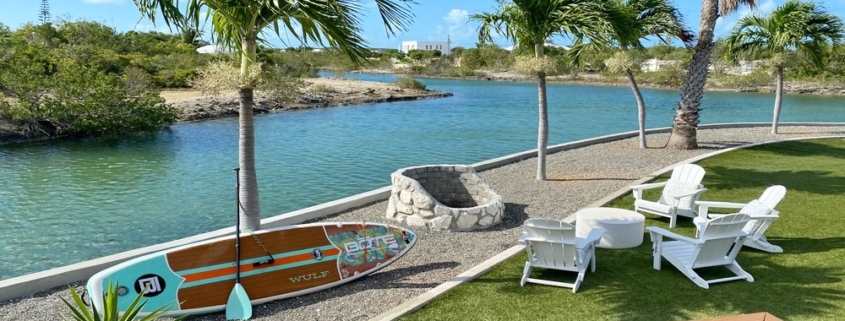 waterfront-turks-caicos-homes-for-sale-palm-point-view of canal, firepit, seating and paddle board