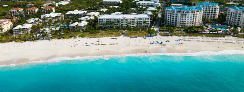 pinnacle-luxury-grace-bay-beachfront-drone view showing beach and area