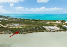 turks-caicos-waterfront-turtle-tail-home-site drone view with arrow showing location