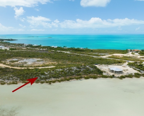 turks-caicos-waterfront-turtle-tail-home-site drone view with arrow showing location